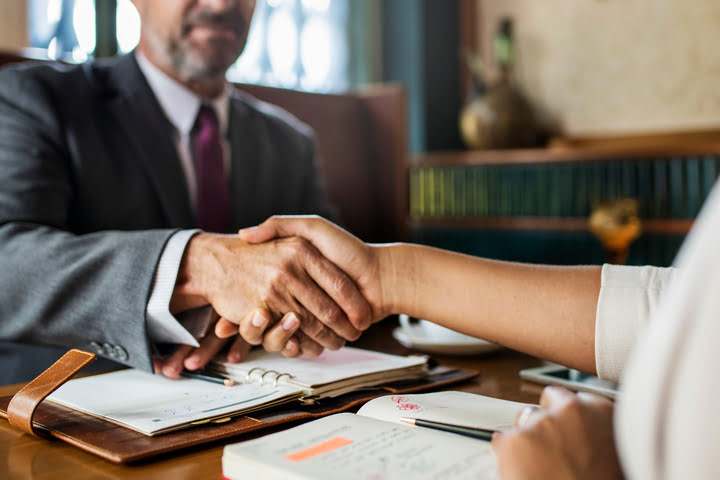 Two persons shaking hands
