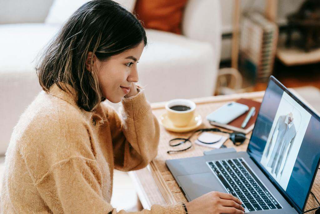 A woman on a laptop. Cover for the article "Florida Remote Worker Taxes"