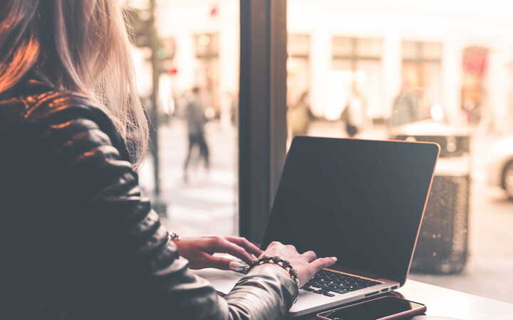 Woman on a laptop understanding Florida Remote Worker Taxes